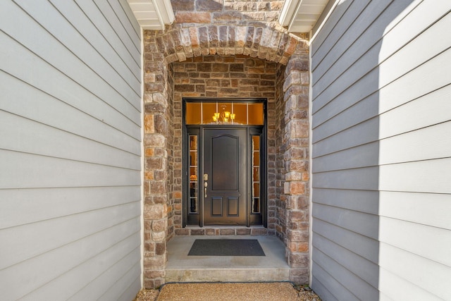 entrance to property featuring stone siding