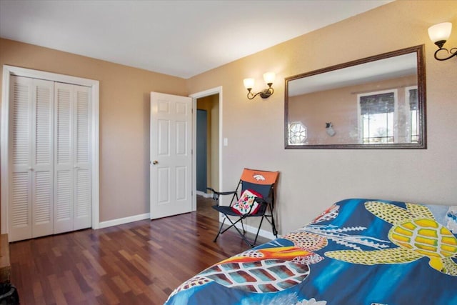 bedroom with a closet, baseboards, and wood finished floors