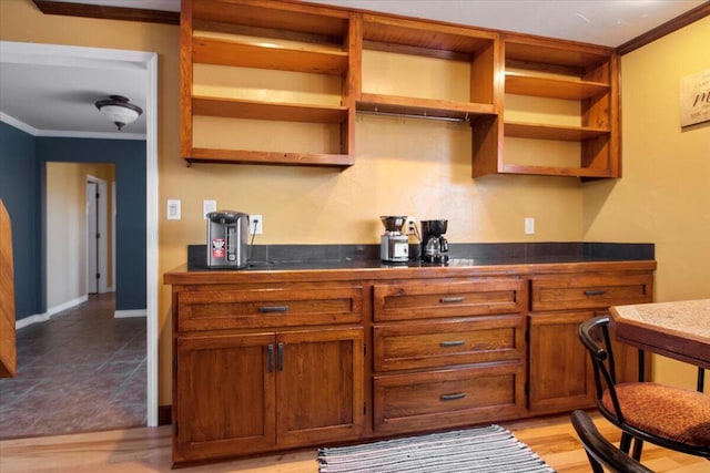 kitchen with dark countertops, ornamental molding, brown cabinets, and open shelves