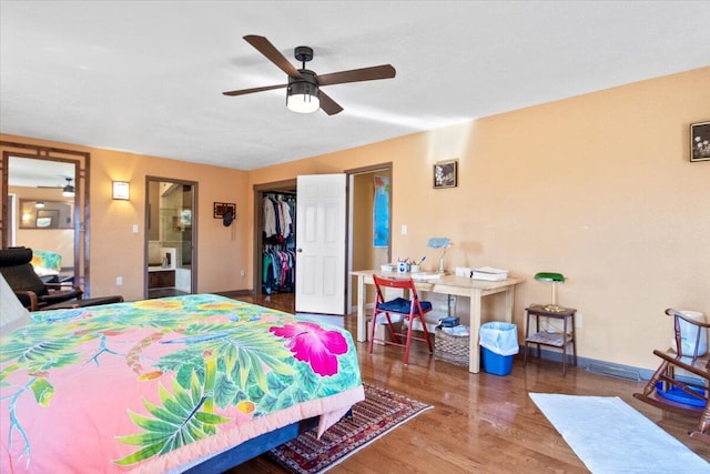 bedroom with a ceiling fan, wood finished floors, a closet, and baseboards