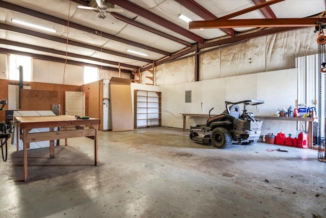 garage featuring electric panel and a workshop area