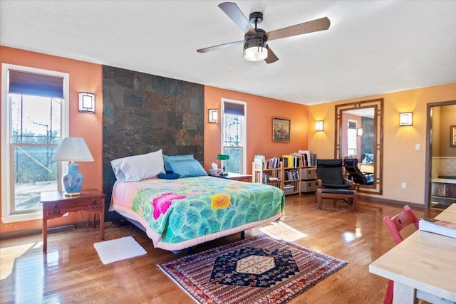 bedroom featuring wood finished floors and baseboards