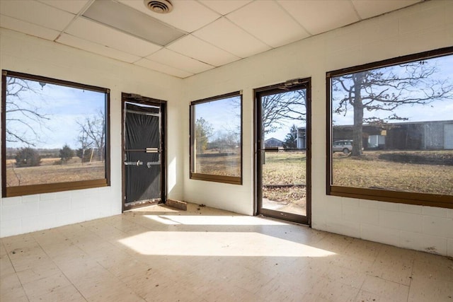 unfurnished sunroom with visible vents and a paneled ceiling