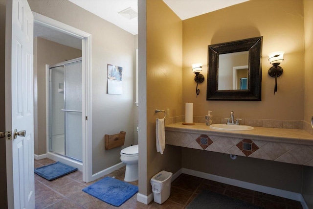 full bathroom with visible vents, toilet, a stall shower, a sink, and tile patterned flooring