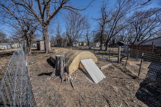 view of storm shelter with fence