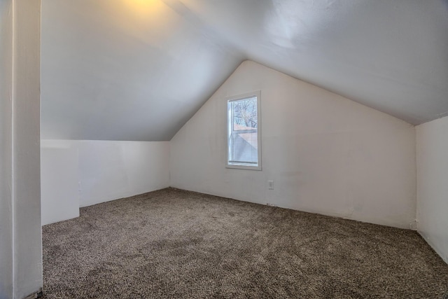 bonus room with carpet floors and vaulted ceiling