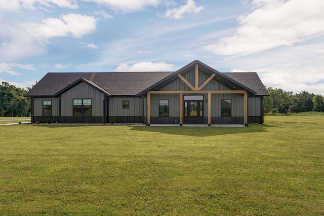 modern inspired farmhouse with roof with shingles and a front yard