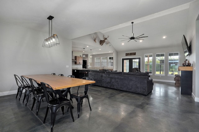 dining space with vaulted ceiling, concrete floors, recessed lighting, and baseboards