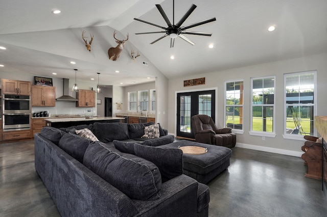 living area featuring baseboards, french doors, concrete floors, high vaulted ceiling, and recessed lighting