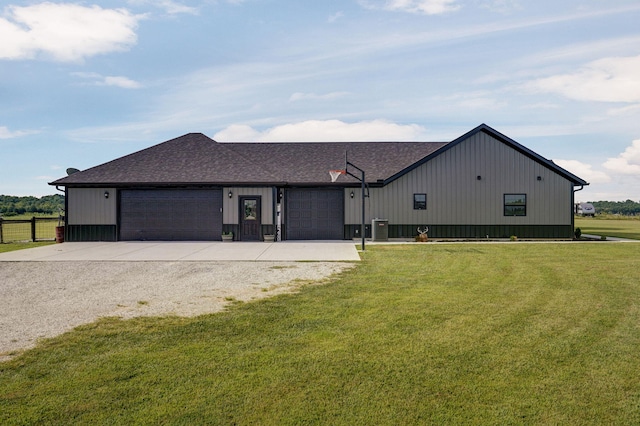 view of front of house with an attached garage, cooling unit, fence, concrete driveway, and a front lawn