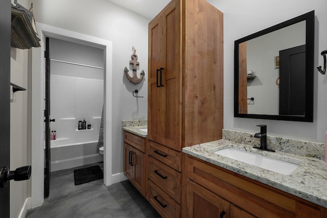 bathroom with toilet, concrete floors, a sink, shower / bathing tub combination, and double vanity