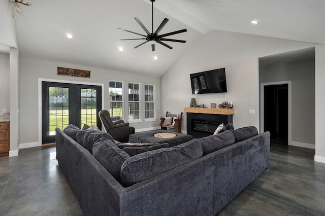 living room with concrete flooring, a glass covered fireplace, french doors, and baseboards