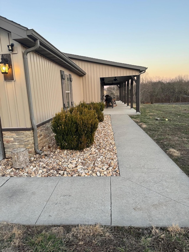 view of home's exterior with board and batten siding and stone siding