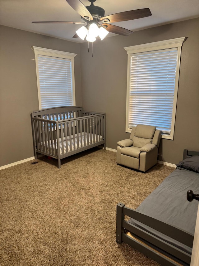 bedroom with ceiling fan, carpet floors, and baseboards