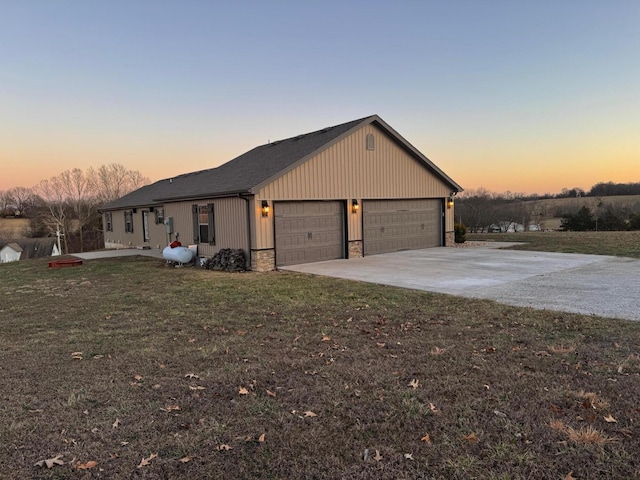 view of front of property with stone siding, driveway, and a front lawn