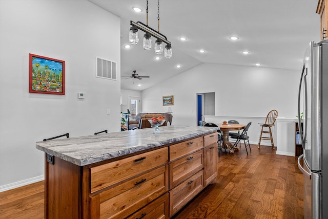 15221 Cleveland Rd, Houston, MO 65483 - kitchen with visible vents, a ceiling fan, freestanding refrigerator, dark wood-type flooring, and a kitchen island