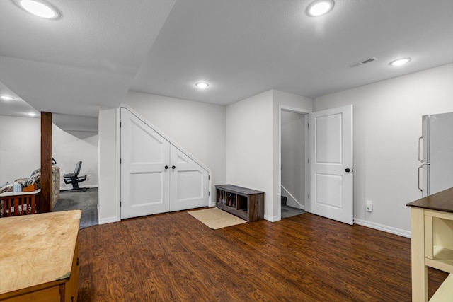 15221 Cleveland Rd, Houston, MO 65483 - finished basement with recessed lighting, visible vents, stairs, freestanding refrigerator, and dark wood-style floors
