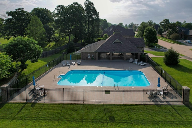 pool featuring fence, a yard, and a patio