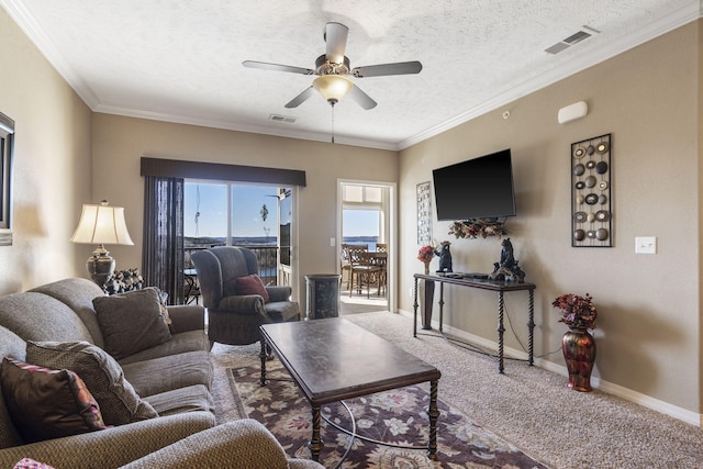 living room with a textured ceiling, carpet flooring, visible vents, and baseboards