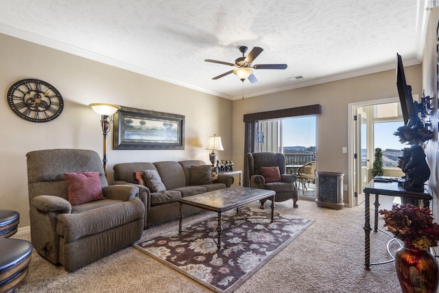 carpeted living room with visible vents, ornamental molding, ceiling fan, and a textured ceiling