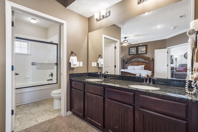 ensuite bathroom with a ceiling fan, double vanity, a sink, and ensuite bathroom