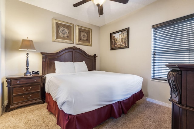 bedroom with light carpet, ceiling fan, and baseboards