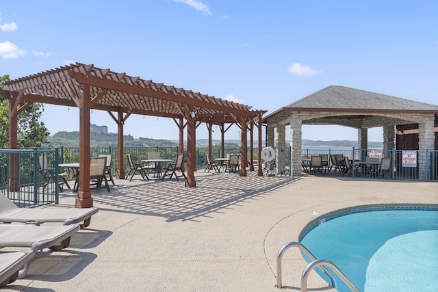 pool featuring a patio area, fence, and a pergola