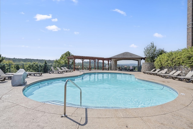 pool featuring a pergola, fence, a gazebo, and a patio