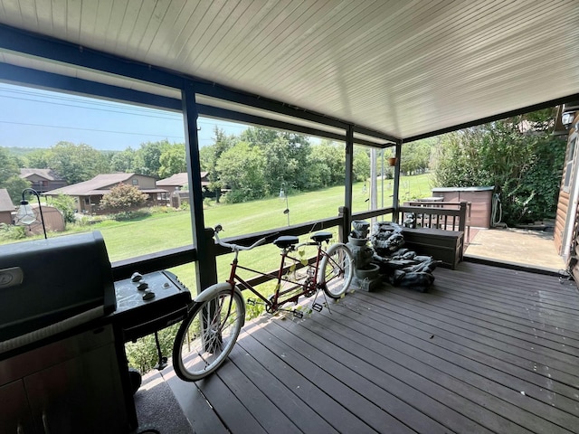 wooden deck featuring a yard