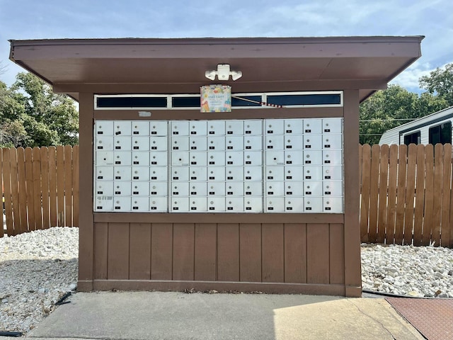 view of community with mail area and fence