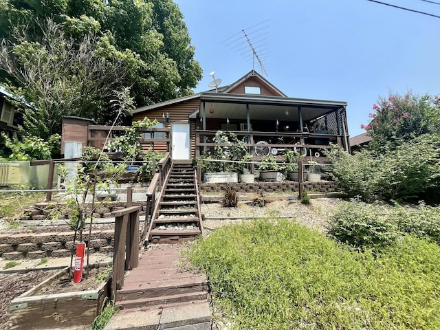 back of house featuring stairs