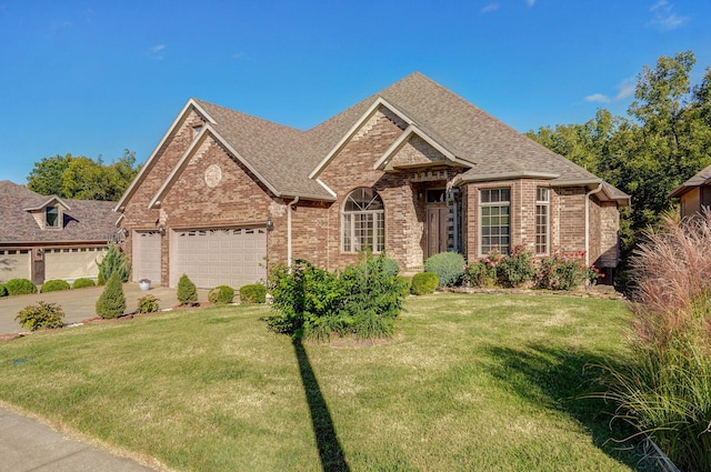 view of front of property featuring an attached garage, brick siding, roof with shingles, and a front yard