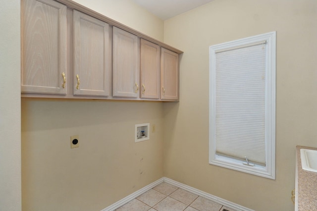 washroom with cabinet space, light tile patterned floors, baseboards, hookup for a washing machine, and electric dryer hookup