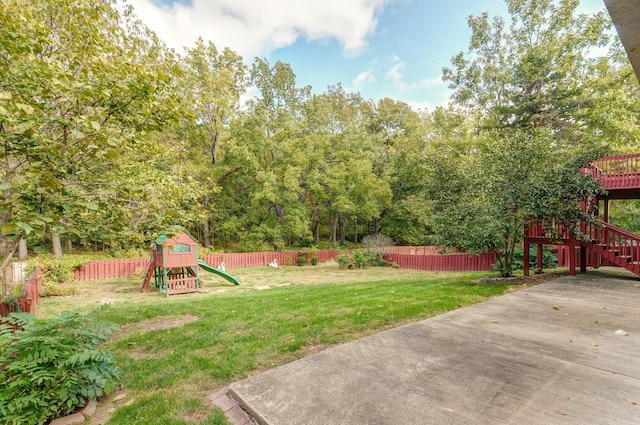 view of yard featuring stairs, a playground, and a fenced backyard