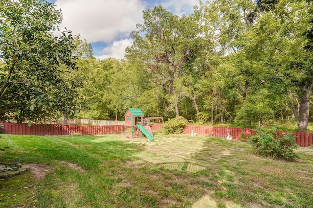 view of yard with a fenced backyard and a playground