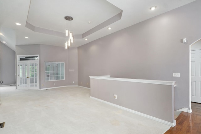 spare room featuring visible vents, baseboards, a raised ceiling, and recessed lighting