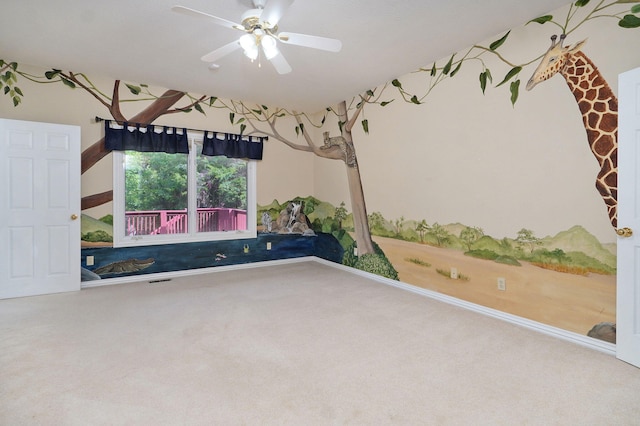 unfurnished room featuring ceiling fan and carpet floors