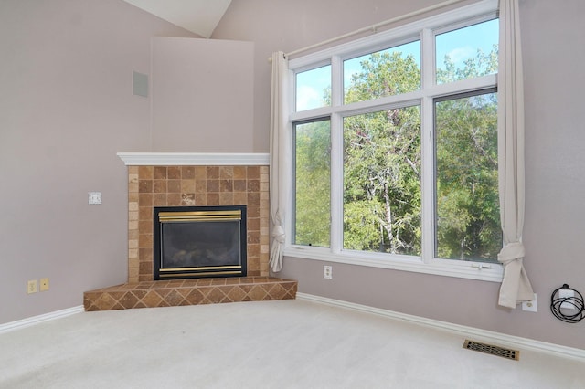 unfurnished living room featuring baseboards, a fireplace, visible vents, and carpet flooring