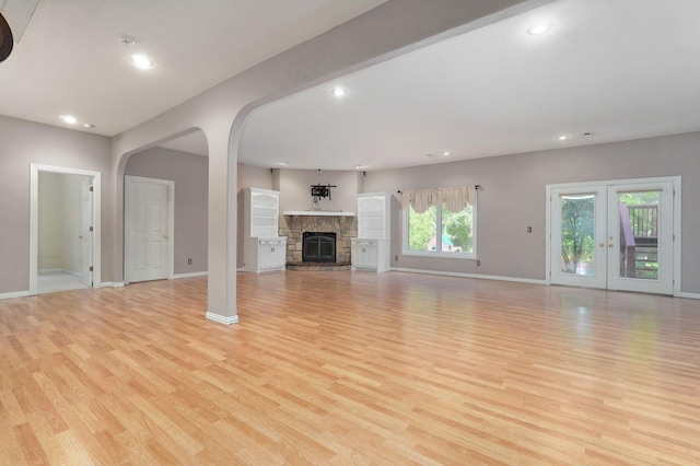 unfurnished living room featuring light wood-type flooring, baseboards, and recessed lighting