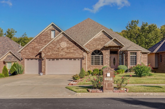 view of front of home featuring a garage, concrete driveway, brick siding, and a shingled roof