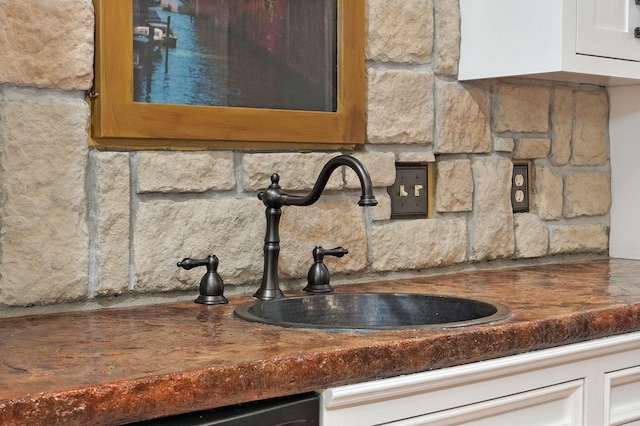 details featuring tasteful backsplash and a sink