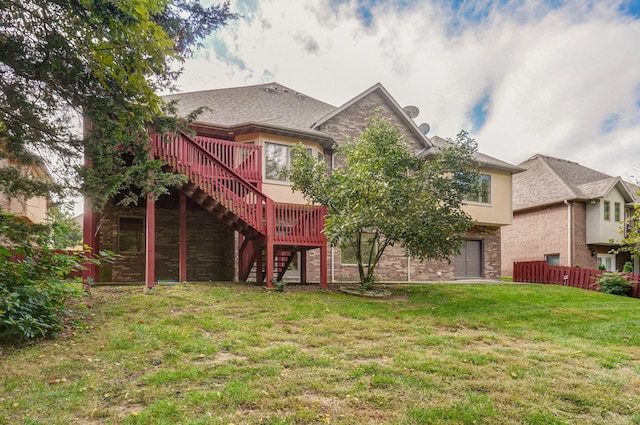 back of property with stucco siding, a lawn, stairway, fence, and stone siding