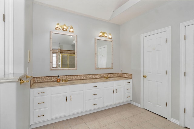 bathroom featuring double vanity, a sink, and tile patterned floors