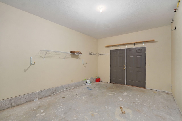 interior space featuring concrete flooring and a textured ceiling