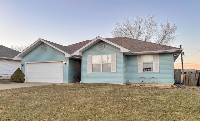 ranch-style home featuring a garage, fence, driveway, roof with shingles, and a front lawn