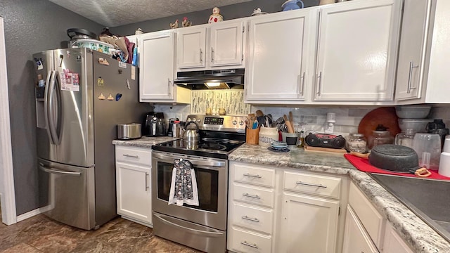 kitchen with tasteful backsplash, light countertops, appliances with stainless steel finishes, a textured ceiling, and under cabinet range hood