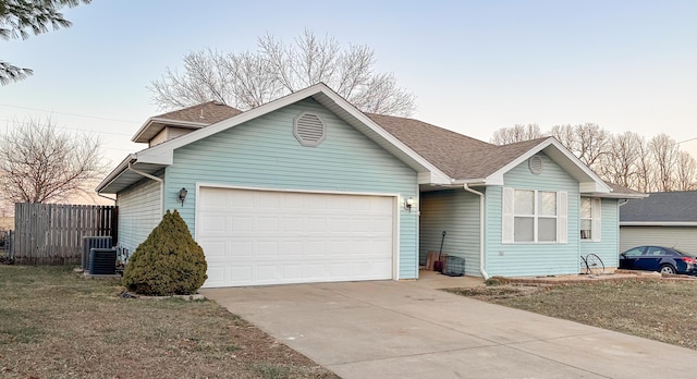 single story home with roof with shingles, central air condition unit, concrete driveway, fence, and a garage