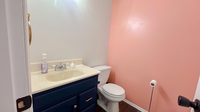 half bath featuring toilet and vanity