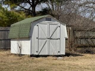 view of shed with fence