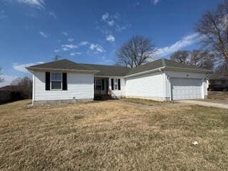 ranch-style home featuring a front lawn and an attached garage